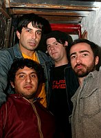 The Shins shot at Fish Bar NYC and at El Maguey Y La Tuna in the Lower East side on Oct. 20, 2003. 

The band is ; 
James Mercer- lead vocals (beard)
 Marty Crandall - keys, vox (blue cap)
 David Hernandez -bass (jeans jacket)
 Jesse Sandoval- drums  (red jacket)

Photo credit; Rahav Segev for The New York Times. 